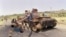 FILE - Eritrean children play on a destroyed Ethiopian army tank, June 7, 1991, near Amara, Eritrea.