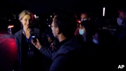 Thea Fischer of the World Health Organization team speaks to journalists outside after a WHO-China Joint Study Press Conference held at the end of the WHO mission in Wuhan, China, Feb. 9, 2021.