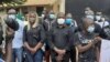 Members of the Union of Journalists and Technicians of the Guinea-Bissau Media, wearing COVID masks, hold a vigil outside Radio Capital FM in Bissau, Guinea-Bissau, Aug. 6, 2020.