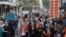 In this image made from video provided by AUBC, people march and shout slogans during a protest against gender-based violence, in Melbourne, Australia, April 28, 2024. Officials met in Canberra Wednesday to discuss ways to address the issue.