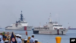 FILE - The U.S. Coast Guard National Security Cutter Bertholf (WMSL 750), left, and the Philippine Coast Guard ship BRP Batangas arrive, May 15, 2019, in Manila, Philippines, after taking part in a joint exercise off the South China Sea.