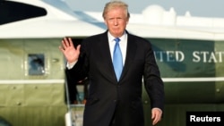 U.S. President Donald Trump waves before his departs from Newark Liberty International airport after a weekend at Trump National Golf Club in Bedminster, New Jersey, June 11, 2017. 