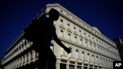 A man walks in front of the Manzana de Gomez Kempinski hotel in Havana, Cuba, May 8, 2017. In the heart of the capital of a nation founded on ideals of social equality, the business arm of the Cuban military has transformed a century-old shopping arcade into a five-star hotel.