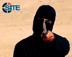 FILE - A masked, black-clad militant, who has been identified by the Washington Post newspaper as a Briton named Mohammed Emwazi, brandishes a knife in this still image from a 2014 video obtained from SITE Intel Group.