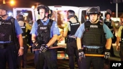 FILE - Police are deployed in Ferguson, Missouri, Aug. 10, 2015. 