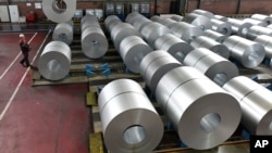 FILE - Steel coils are stored at the Thyssenkrupp steel factory in Duisburg, Germany. Duisburg is the biggest steel producer site in Europe, April 27, 2018. Many small companies in the United States can expect to pay more for steel and aluminum following 