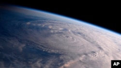 This photo made available by NASA shows Hurricane Harvey over Texas on Aug. 26, 2017, seen from the International Space Station.