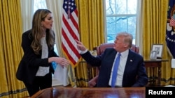 FILE - U.S. President Donald Trump confers with White House Communications Director Hope Hicks, at the White House in Washington, January 17, 2018. 