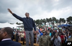 FILE - In this Saturday, Sept. 5, 2015 file photo, Rwanda's President Paul Kagame waves to the crowd before speaking at a baby gorilla naming ceremony in Kinigi, northern Rwanda.
