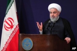 In this photo released by the official website of the office of the Iranian Presidency, President Hassan Rouhani addresses the nation in a televised speech in Tehran, Aug. 6, 2018.