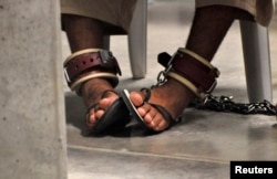 FILE - A detainee's feet are seen shackled to the floor inside the Camp 6 high-security detention facility at Guantanamo Bay U.S. Naval Base April 27, 2010.
