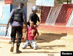 Policemen detain a protester during clashes in Lubumbashi, Democratic Republic of Congo, Nov. 10, 2015.