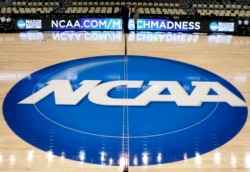 FILE - The NCAA logo is seen at center court in Pittsburgh, Pa., March 18, 2015.