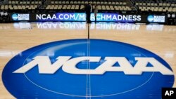 FILE - The NCAA logo is seen at center court at The Consol Energy Center in Pittsburgh, Pa., March 18, 2015.