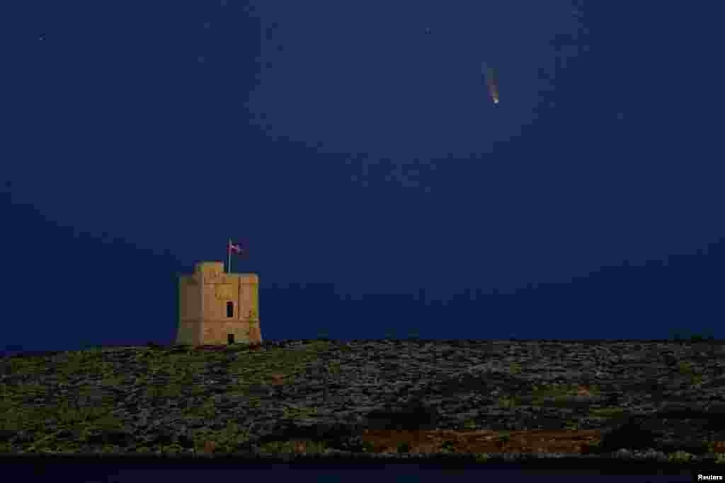 The Comet C/2020 or "Neowise" is seen in the sky behind St. Mark's Tower, a 17th century coastal fortification near the village of Bahar ic-Caghaq, Malta.
