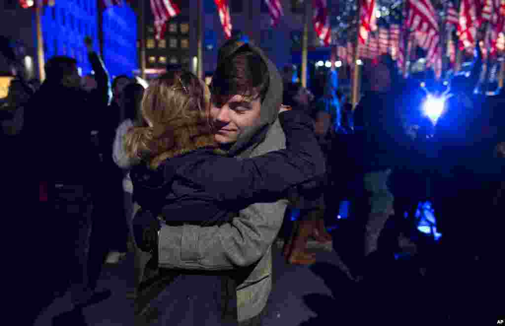 Ryan Charchian, 18, of New York, hugs Allie Rapa, 19, of New York after news reports projected President Barack Obama to win a second term as they celebrated in New York, Nov. 6, 2012.