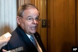Sen. Bob Menendez, D-N.J., talks with reporters on Capitol Hill, Thursday, Oct. 11, 2018 in Washington.