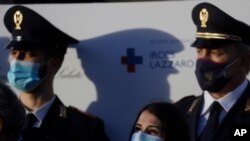 Italian Nurse Claudia Alivernini, the first person in Italy to receive the Pfizer coronavirus vaccine, looks up after speaking with journalists outside the Spallanzani hospital in Rome, Dec. 27, 2020.