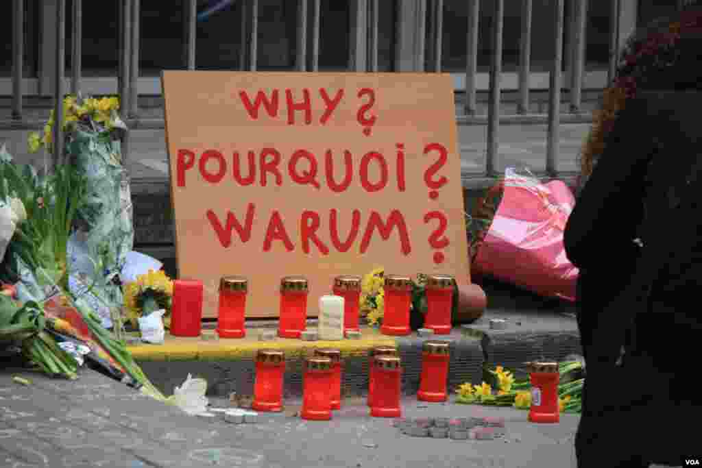 A placard outside one of the entrances to the Maelbeek metro station asks ‘why’ while other writing expresses calls for both peace and anger in Brussels, Belgium, March 24, 2016. (H. Murdock/VOA)