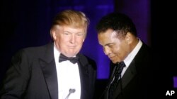 FILE - Donald Trump accepts his Muhammad Ali award from Ali at the boxing legend's "Celebrity Fight Night XIII" in Phoenix, Ariz., March 24, 2007.