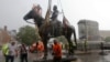 Workers remove the statue of Confederate General Stonewall Jackson from it's pedestal on Monument Avenue, July 1, 2020, in Richmond, Virginia.
