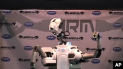 Some day, a robot might find a hidden bomb or help a disabled person select a shirt and button it.