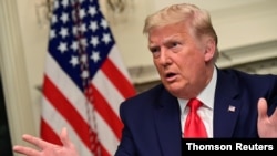 US President Donald Trump speaks to reporters after he participated in a Thanksgiving video teleconference with members of the military forces at the White House, Nov. 26, 2020.