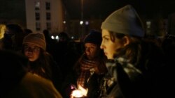 Migrants rights activists hold candles during a gathering outside Calais, France, Nov. 25, 2021. At least 27 migrants died when their small boat sank in an attempted crossing of the English Channel, a French government official said Nov. 24, 2021.