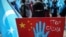 A protester from the Uyghur community living in Turkey holds up an anti-China placard during a protest against the visit of China's Foreign Minister Wang Yi to Turkey, in Istanbul, March 25, 2021.