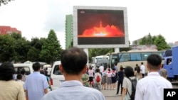 People watch a news broadcast of a missile launch in Pyongyang, North Korea, July 29, 2017. North Korean leader Kim Jong Un said Saturday the second flight test of an intercontinental ballistic missile demonstrated his country can hit the U.S. mainland.
