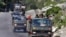 An Indian Army convoy moves along a highway leading to Ladakh, at Gagangeer in Kashmir's Ganderbal district, June 18, 2020.