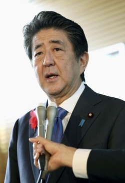 Japan's Prime Minister Shinzo Abe speaks to the media about North Korea's latest launch of ballistic missiles, in Tokyo, in this photo taken by Kyodo Oct. 2, 2019.