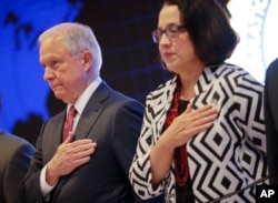 U.S. Attorney General Jeff Sessions and U.S. Ambassador to El Salvador Jean Elizabeth Manes stand during the playing of the U.S. national anthem during a graduation ceremony at the International Law Enforcement Academy in San Salvador, El Salvador, July 2