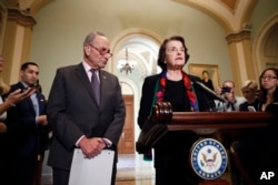 Senate Judiciary Committee Ranking Member Sen. Dianne Feinstein, D-Calif., speaks to the media, accompanied by Senate Minority Leader Chuck Schumer, D-N.Y., Oct. 4, 2018 in Washington.