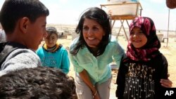 U.S. Ambassador to the United Nations Nikki Haley, speaks with Syrian refugee children, during a visit to the Zaatari Refugee Camp, Jordan, May 21, 2017. 