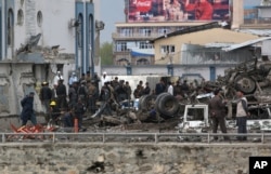 Afghan security forces inspect the site of a Taliban-claimed deadly suicide attack in Kabul, Afghanistan, April 19, 2016.