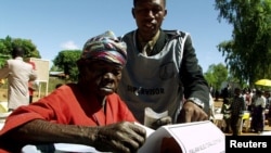 FILE - An elderly woman casts her vote in Malawi's general election in Machinga district, north of the commercial capital, Blantyre.