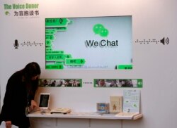 FILE - A counter promoting WeChat, a product of Tencent, for reading books for the blind is displayed at a news conference in Hong Kong, March 18, 2015.