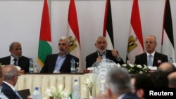 Hamas Chief Ismail Haniyeh speaks as he sits next to Palestinian Prime Minister Rami Hamdallah during the meeting in Gaza City, Oct. 3, 2017. 