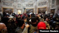 FILE - Trump supporters breach the U.S. Capitol in Washington, Jan. 6, 2021.