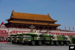 在北京纪念抗日战争胜利70周年阅兵活动中，军车载着东风-26中程弹道导弹驶过天安门（2015年9月3日）