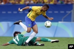 Brazil's Neymar, top, tries control the ball under pressure from Iraq's Alaa Ali during a group A match of the men's Olympic football tournament between Brazil and Iraq at the National Stadium in Brasilia, Brazil, Aug. 7, 2016.