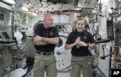 In this image made from video provided by NASA, astronaut Kate Rubins, right, speaks during an interview aboard the International Space Station on July 13, 2016.