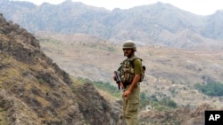 FILE - A Pakistan army soldier stands guard in the Pakistani tribal area of Khyber near the Torkham border post between Pakistan and Afghanistan, June 15, 2016.