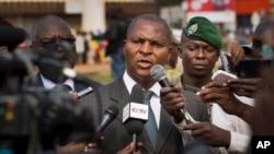 FILE - Faustin-Archange Touadera (C) is seen speaking to the media in downtown Bangui, Central African Republic, Jan. 5, 2013.