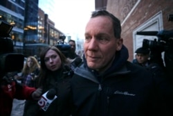FILE - Harvard University professor Charles Lieber is surrounded by reporters as he leaves the Moakley Federal Courthouse in Boston, Jan. 30, 2020.
