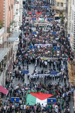 FILE - Demonstrators march with a giant Palestinian flag May 31, 2018 at Istiklal avenue in Istanbul, to mark the 8th anniversary of a deadly raid on Turkish-registered Mavi Marmara.