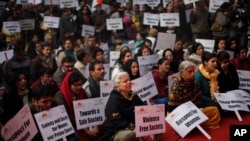 Indians sing devotional songs during a gathering to mourn the death of a 23-year old rape victim in New Delhi, India, Jan. 5, 2013.