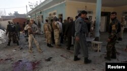 Afghan security forces inspect the site of a suicide attack in Jalalabad, Afghanistan, Jan. 17, 2016. 