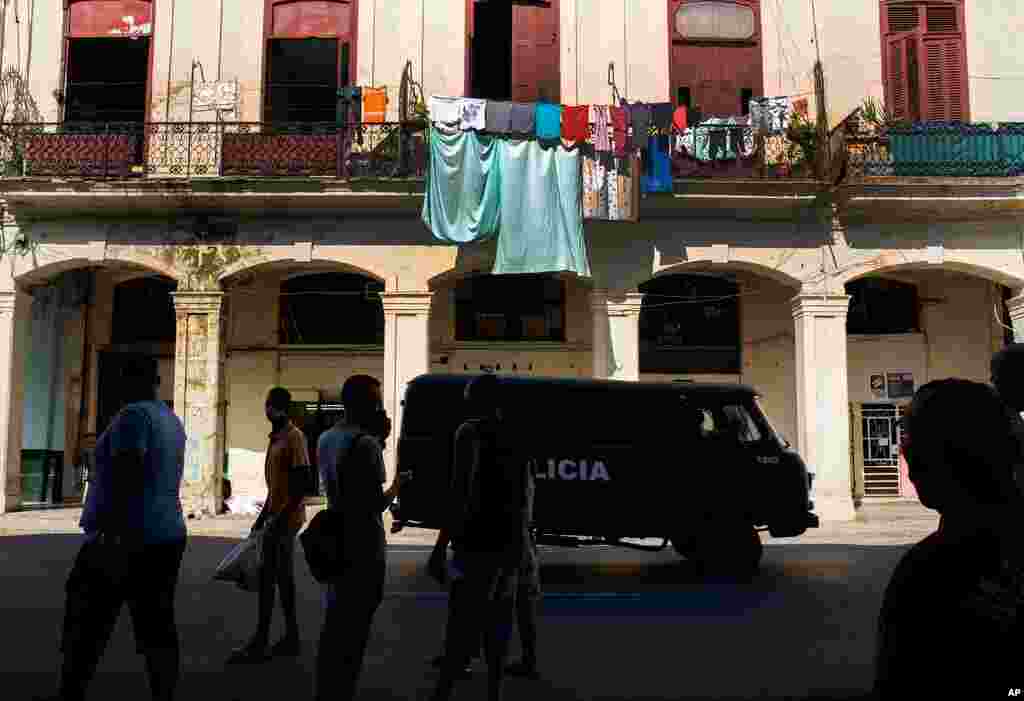 A police vehicle patrols through Old Havana, Cuba, July 12, 2021, the day after protests against food shortages and high prices amid the coronavirus crisis. 